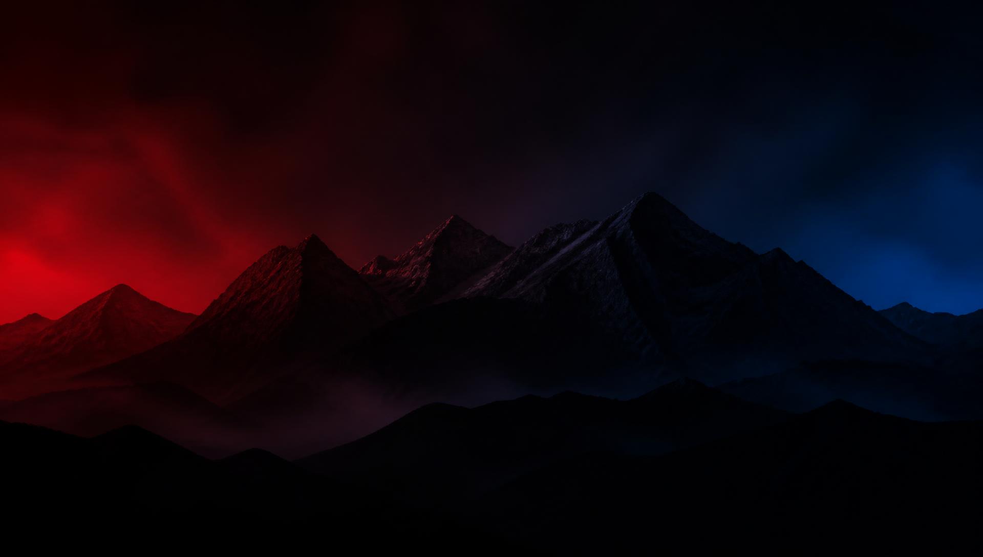 Himalayan mountain silhouettes lit by red and blue light